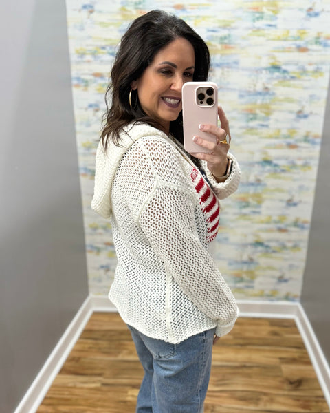 woman wearing american flag knit sweater in white