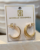 Gold hoop earrings on a Michelle McDowell branded card.
