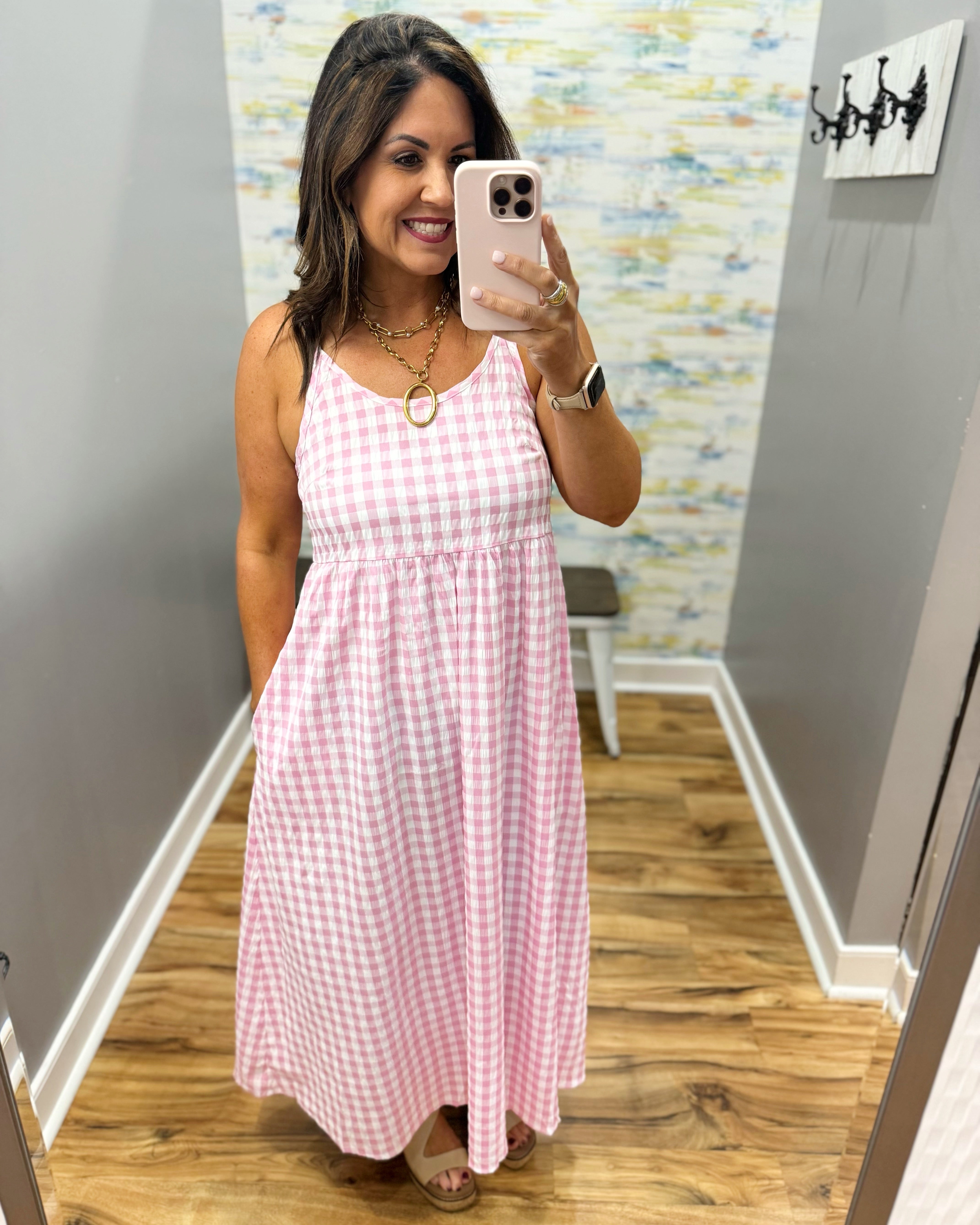 woman wearing gingham print dress in pink.