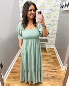 Woman wearing a light green dress.