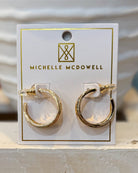 Gold hoop earrings on a Michelle McDowell branded card.