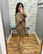 woman taking a selfie wearing a hazelnut mini dress features a beautiful floral print with statement puff sleeves