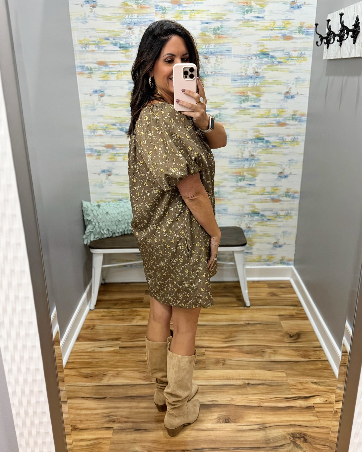 woman taking a selfie wearing a hazelnut mini dress features a beautiful floral print with statement puff sleeves