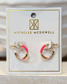 Pair of earrings on a Michelle McDowell branded card.