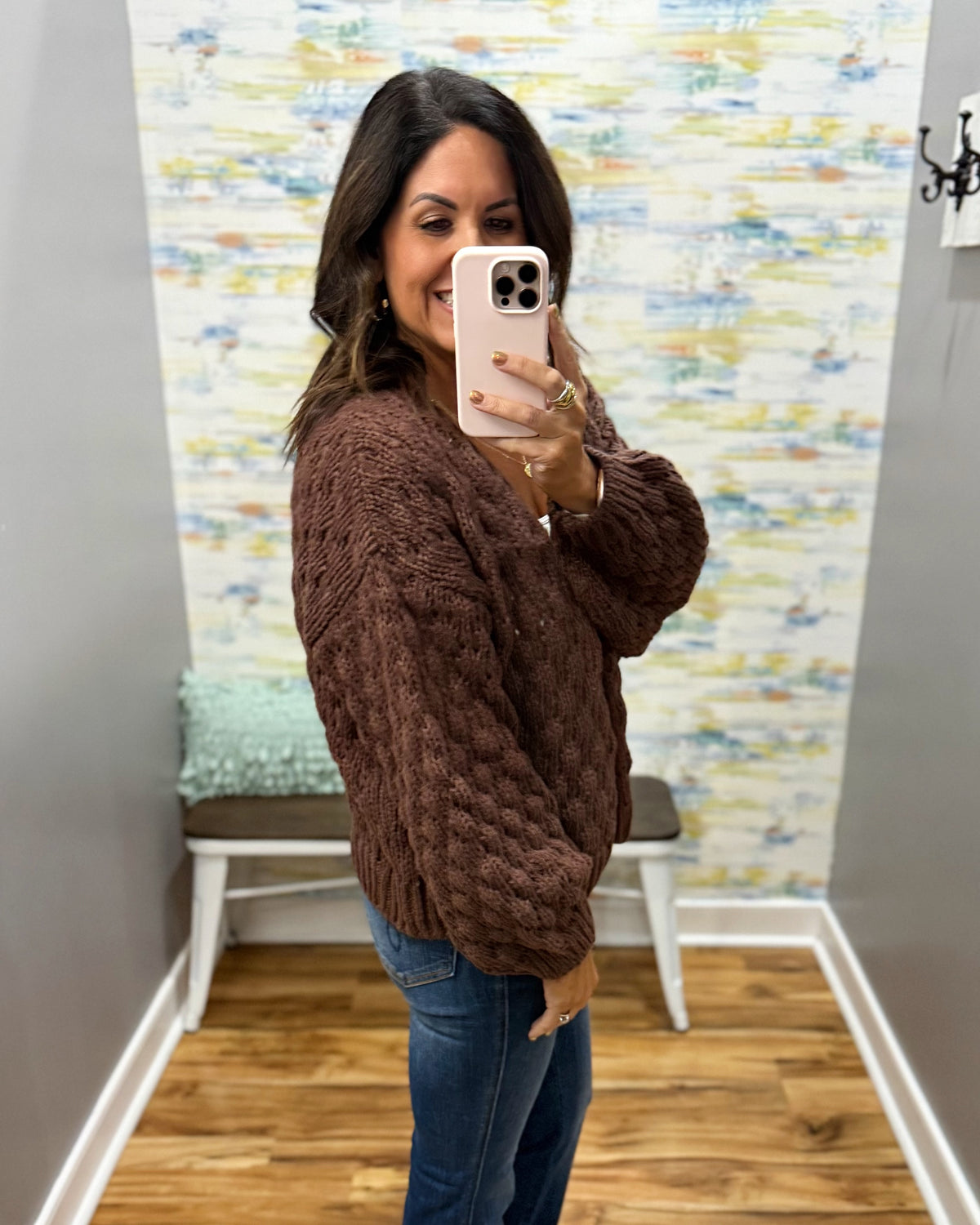 woman wearing a brown crochet sweater cardigan.