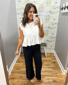 woman wearing navy pants with this top.