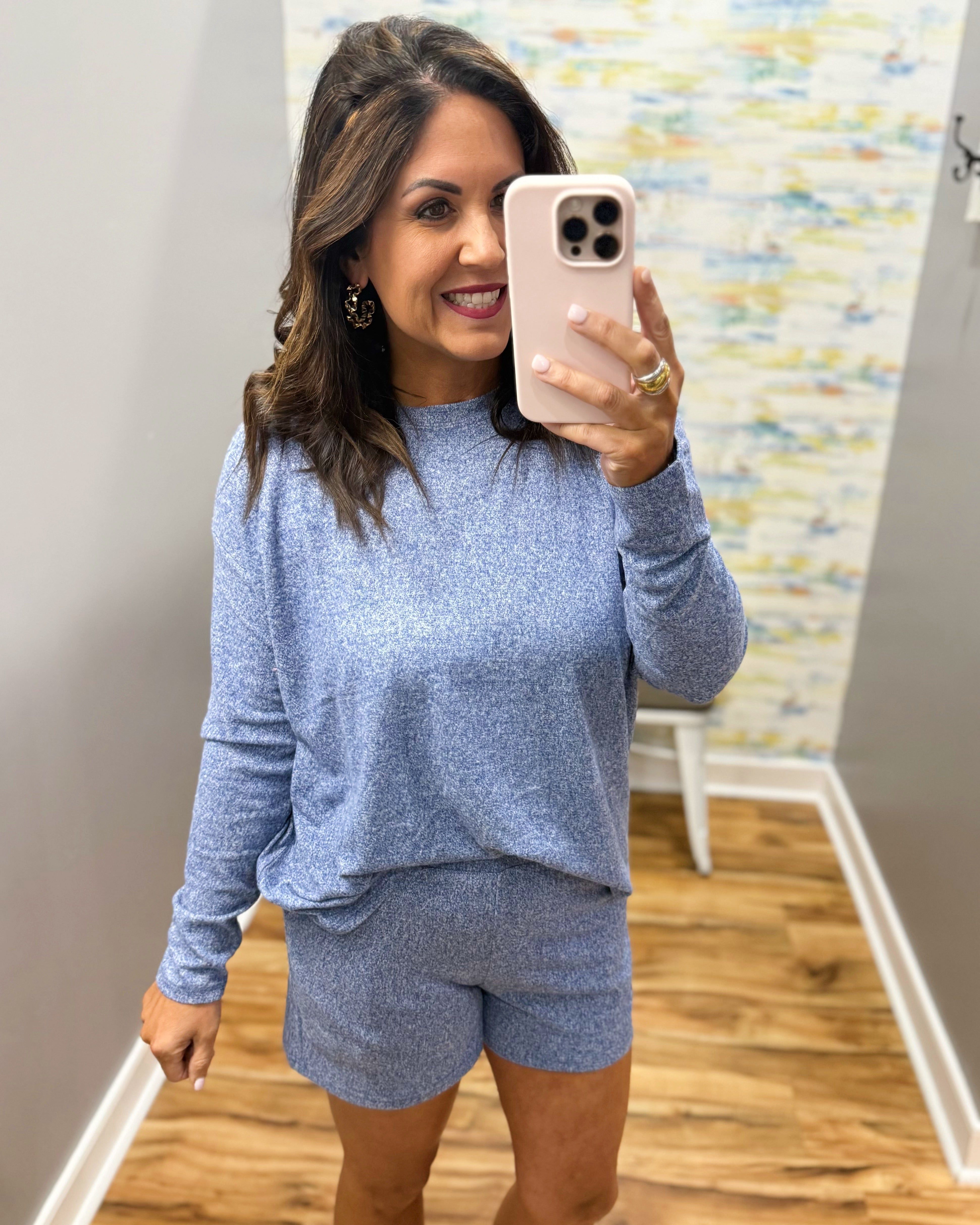 woman wearing light navy lounge top and shorts set.